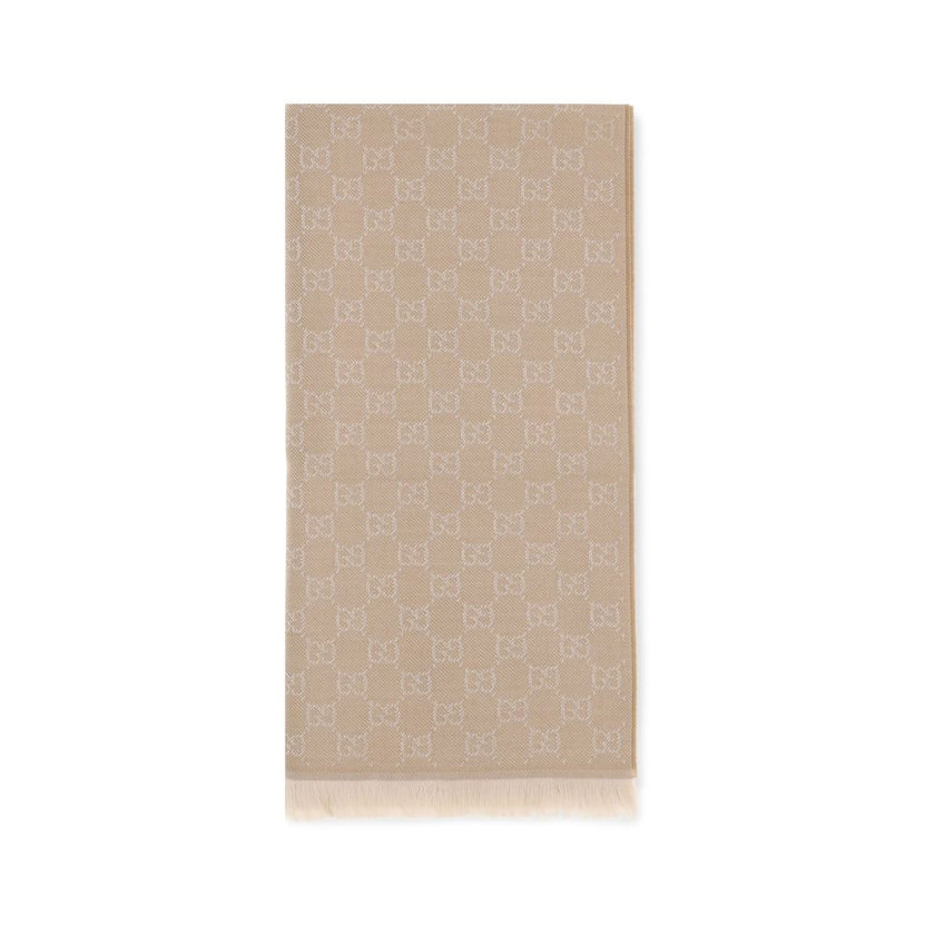 Beige Wool ScarfThe GG Supreme embroidered wool Scarf by Gucci combines warmth and sophistication in a distinctive Maison accessory. Made of pure wool, it features GG embroidery across the entire surface, while frayed ends complete the design with a touch