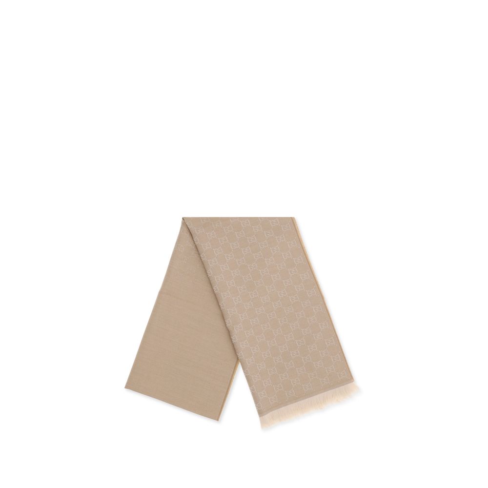 Beige Wool ScarfThe GG Supreme embroidered wool Scarf by Gucci combines warmth and sophistication in a distinctive Maison accessory. Made of pure wool, it features GG embroidery across the entire surface, while frayed ends complete the design with a touch