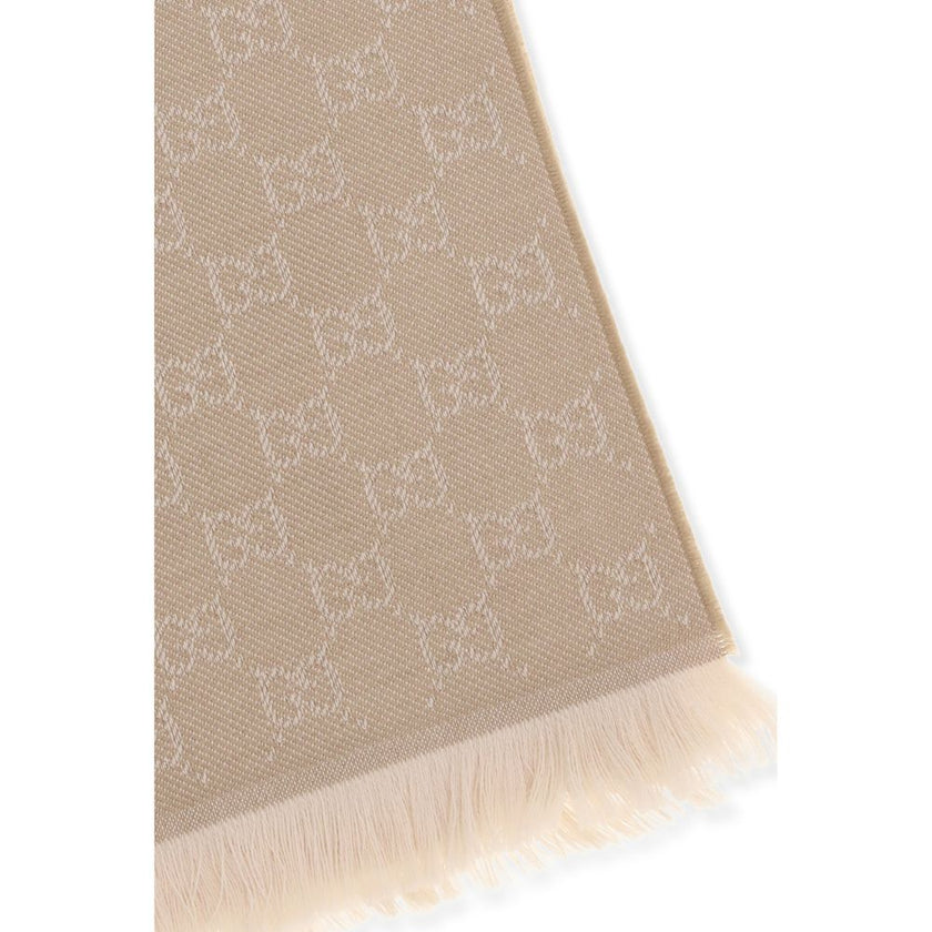 Beige Wool ScarfThe GG Supreme embroidered wool Scarf by Gucci combines warmth and sophistication in a distinctive Maison accessory. Made of pure wool, it features GG embroidery across the entire surface, while frayed ends complete the design with a touch