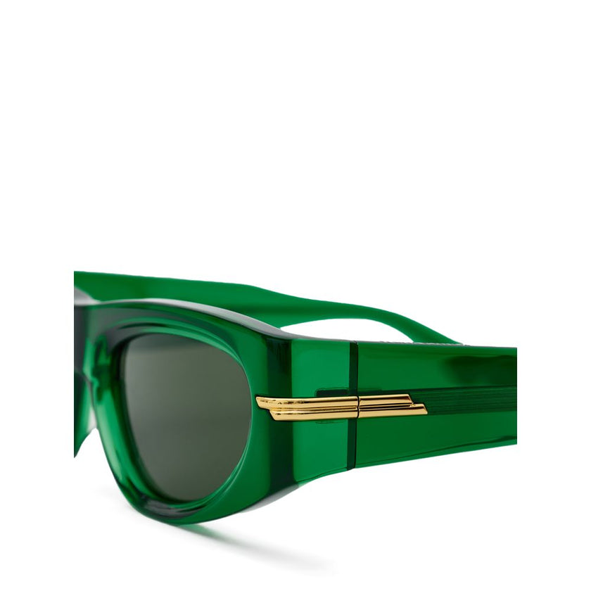 Green Acetate SunglassesBottega Veneta Transparent Green Acetate Sunglasses. Geometric frame, dark green lenses, gold details on the arms. Composition: Acetate Internal SKU: 25AGO34 Brand SKU: 703257V23303354Green Acetate Sunglasses${tagsBottega VenetaGre