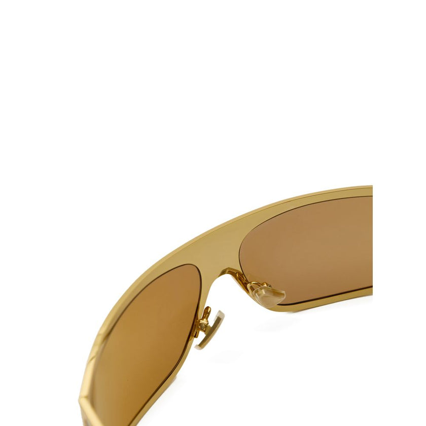 Gold Metal SunglassesBottega Veneta Gold Metal Wraparound Sunglasses. Rectangular wraparound gold metal frame, ochre lenses, and temple details. Composition: Metal Internal SKU: 25AGO37 Brand SKU: 769241V44501431Gold Metal Sunglasses${tagsBottega VenetaGo