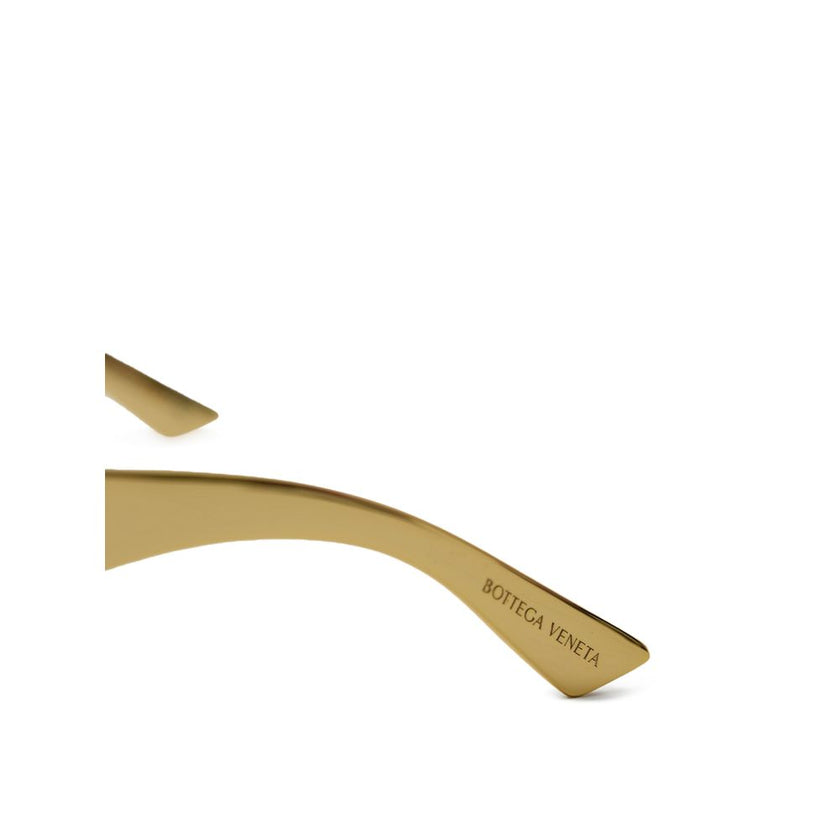 Gold Metal SunglassesBottega Veneta Gold Metal Wraparound Sunglasses. Rectangular wraparound gold metal frame, ochre lenses, and temple details. Composition: Metal Internal SKU: 25AGO37 Brand SKU: 769241V44501431Gold Metal Sunglasses${tagsBottega VenetaGo