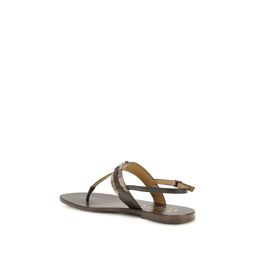 Brown Calf Leather Bos Taurus Flat SandalsThe GG Crossover Sandals by Gucci with Web detail express a sophisticated and distinctive elegance. Crafted with palladium-colored trim and brown leather, they feature the distinctive green and red Web ribbon and