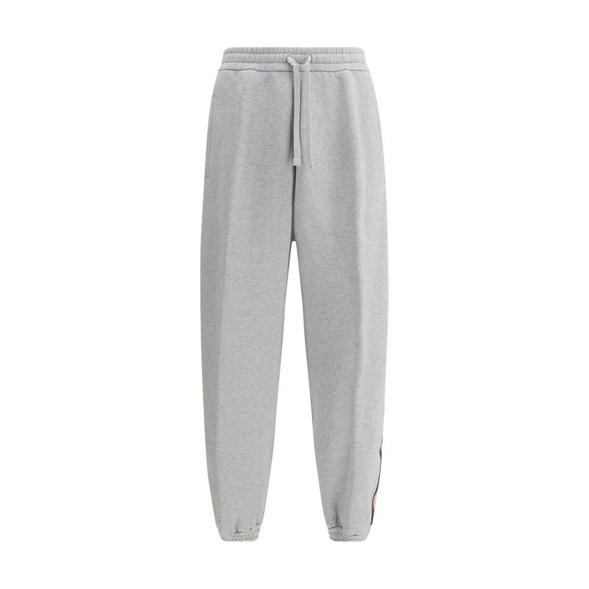 Gray Cotton Joggers (Workout Pants)Gucci’s Cotton Sweatpants are a perfect example of sporty elegance. Featuring side bands in the brand’s iconic colors, they add a distinctive and recognizable touch to the design. The iconic Gucci monogram is stitched on