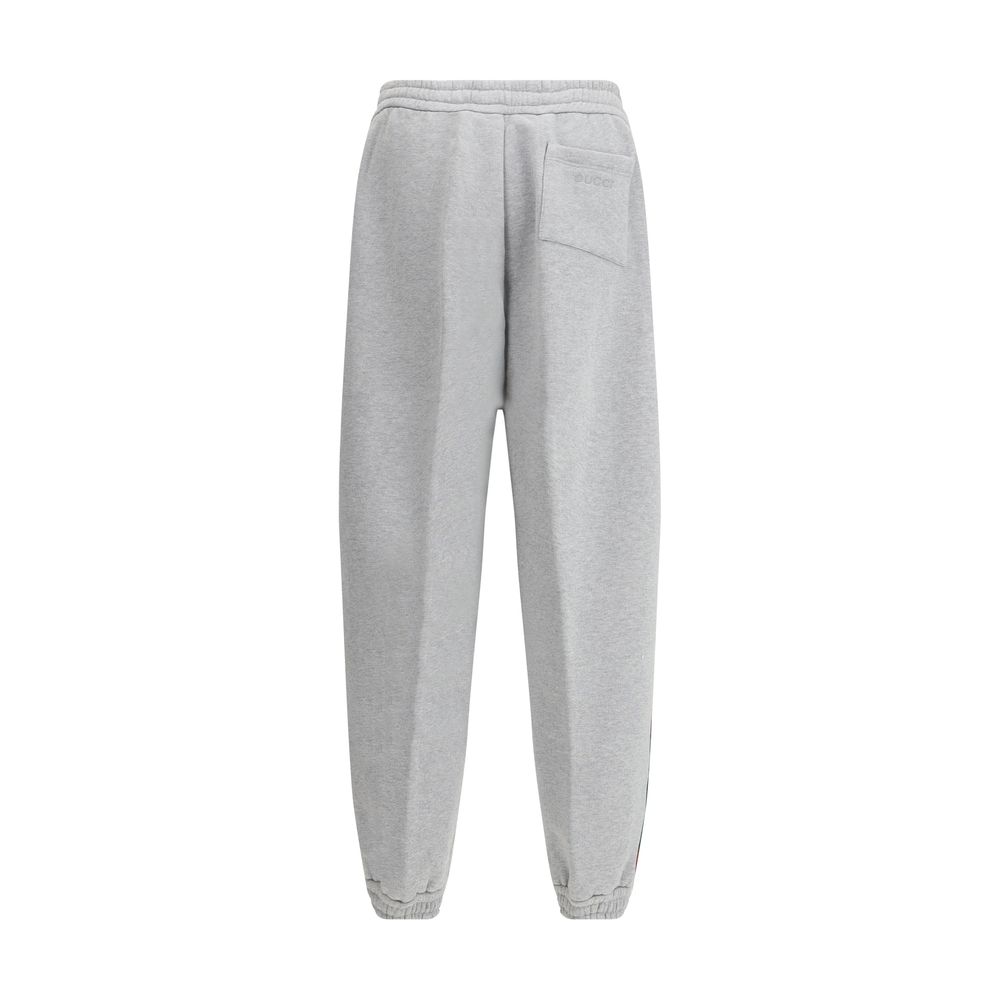 Gray Cotton Joggers (Workout Pants)Gucci’s Cotton Sweatpants are a perfect example of sporty elegance. Featuring side bands in the brand’s iconic colors, they add a distinctive and recognizable touch to the design. The iconic Gucci monogram is stitched on