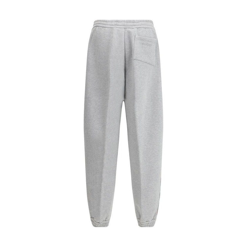 Gray Cotton Joggers (Workout Pants)Gucci’s Cotton Sweatpants are a perfect example of sporty elegance. Featuring side bands in the brand’s iconic colors, they add a distinctive and recognizable touch to the design. The iconic Gucci monogram is stitched on