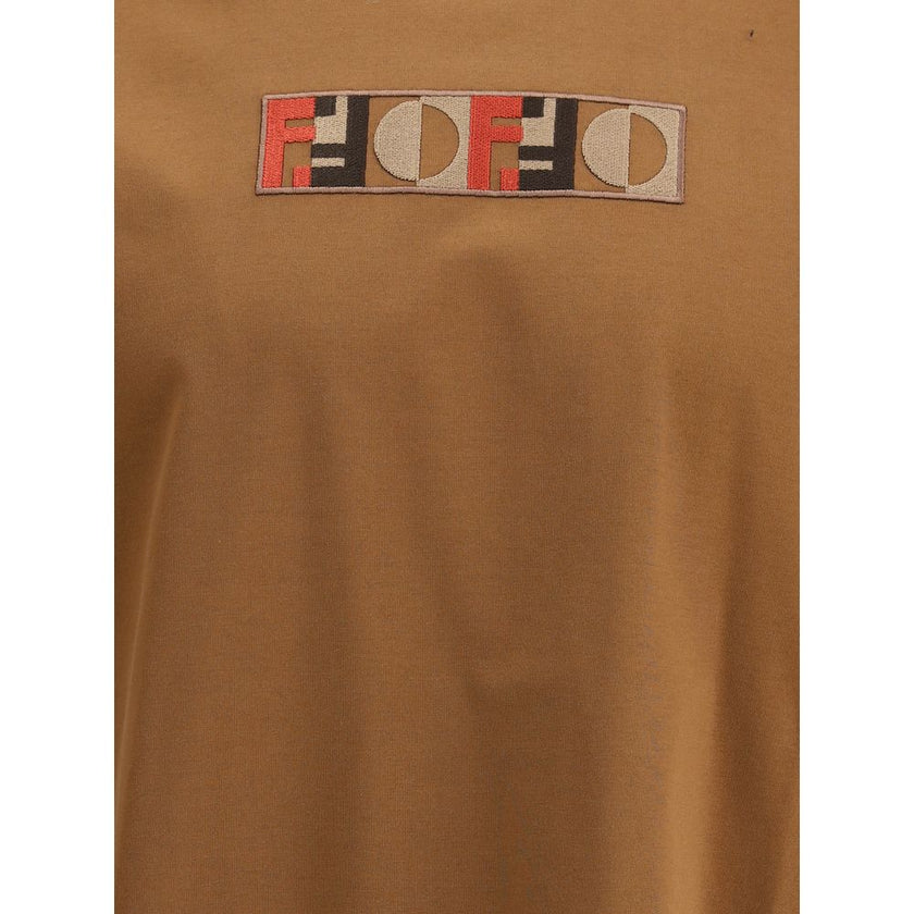Brown Cotton ClothingThe T-Shirt by Fendi, crafted from pure cotton, stands out for its refined yet essential design. The regular fit, crew neckline, and short sleeves make it a versatile piece suitable for any occasion. The three-dimensional embroidered