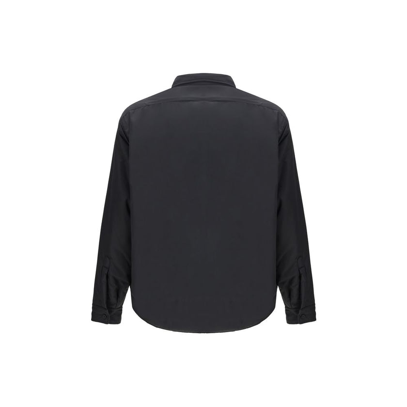 Black Polyester ClothingThe padded Jacket by Balenciaga is crafted from high-quality polyester, designed to provide warmth and comfort while maintaining a sleek aesthetic. It features a pointed collar, front button closure, and buttoned cuffs. The tonal e
