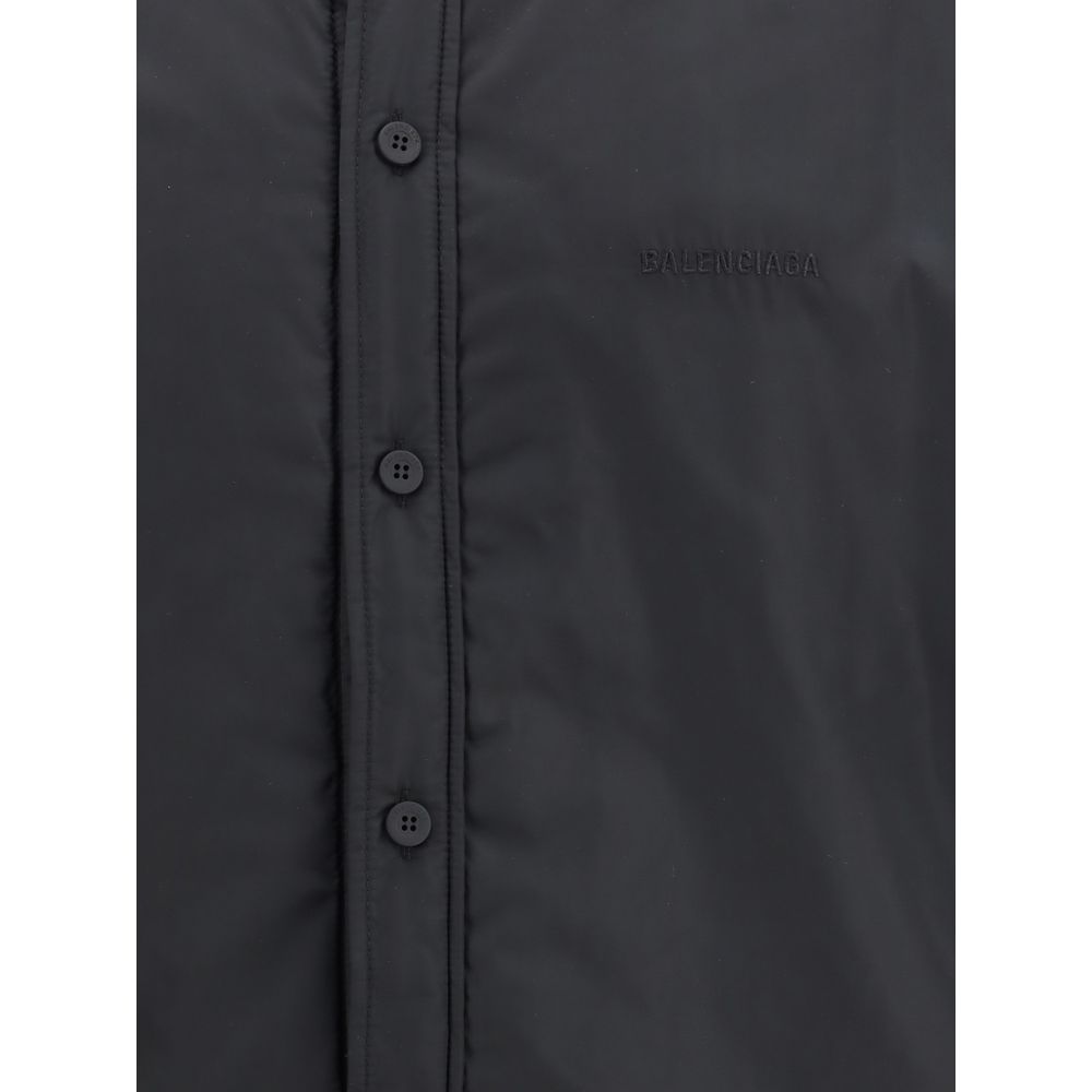 Black Polyester ClothingThe padded Jacket by Balenciaga is crafted from high-quality polyester, designed to provide warmth and comfort while maintaining a sleek aesthetic. It features a pointed collar, front button closure, and buttoned cuffs. The tonal e