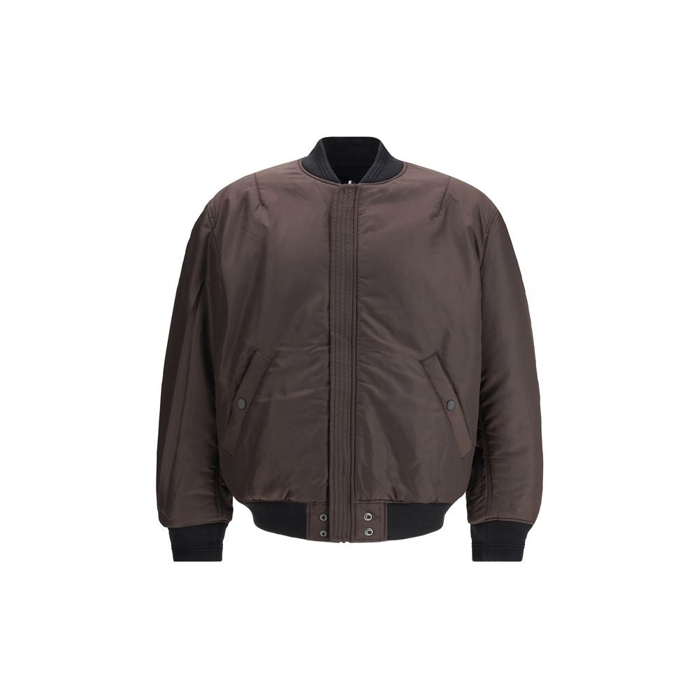 Black Polyamide BomberThe J-Held padded nylon Bomber Jacket by Diesel is crafted from technical fabric made with certified recycled nylon fibers, reflecting the brand’s commitment to sustainability. Lightly padded for warmth and comfort, it features subtl